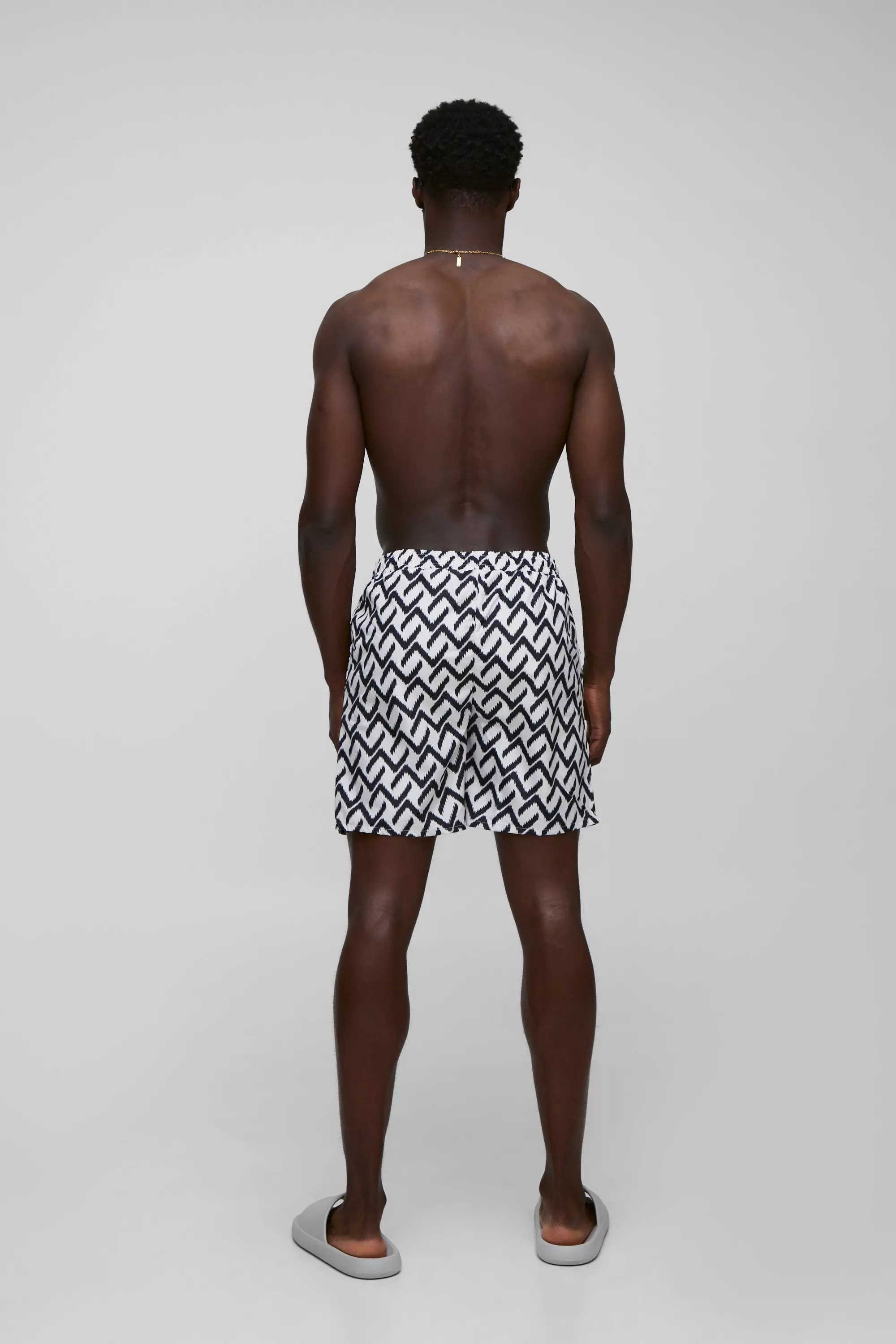 Abstract Pattern Printed Mid Length Swim Trunks | boohooMAN USA