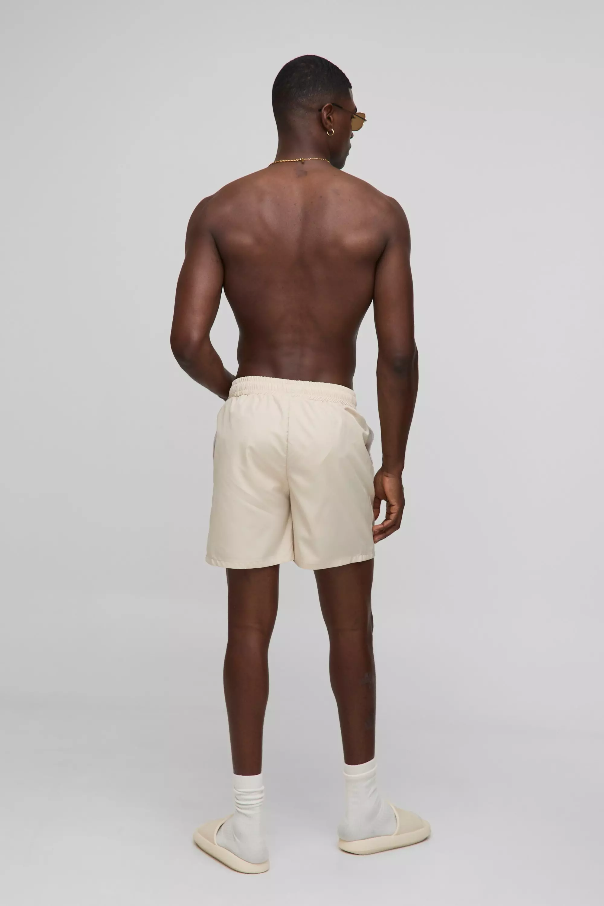 Branded Regular fit Mid length Embroidered Swim Shorts | boohooMAN USA